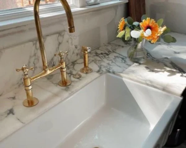 “Brass faucet installed in an indoor sink, a simple home upgrade that adds elegance and value to your kitchen or bathroom.